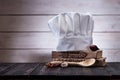 Cook hat, wooden spoons, spices and vegetables on a wooden table.ÃÂ  Royalty Free Stock Photo